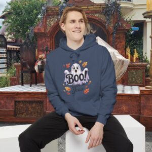 Model on a Halloween set wearing a Gray Boo! -lieve in Jesus Halloween Hoodie, design showing a cute ghost with fall leaves.