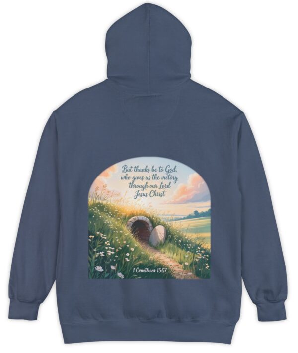 Navy blue Comfort Colors hoodie sweatshirt with a field and an open tomb with the rock rolled away. Printed on it is 1 Corinthians 15:57 But thanks be to God, who gives us the victory through our Lord Jesus Christ.