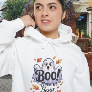 Model on a Halloween set wearing a White Boo! -lieve in Jesus Halloween Hoodie, design showing a cute ghost with fall leaves.