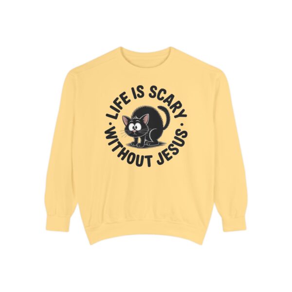 Model on a Halloween set wearing a yellow Life is Scary Without Jesus Halloween Sweatshirt, design showing a cute frightened black cat.