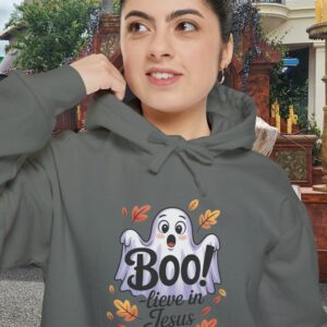 Model on a Halloween set wearing a Gray Boo! -lieve in Jesus Halloween Hoodie, design showing a cute ghost with fall leaves.