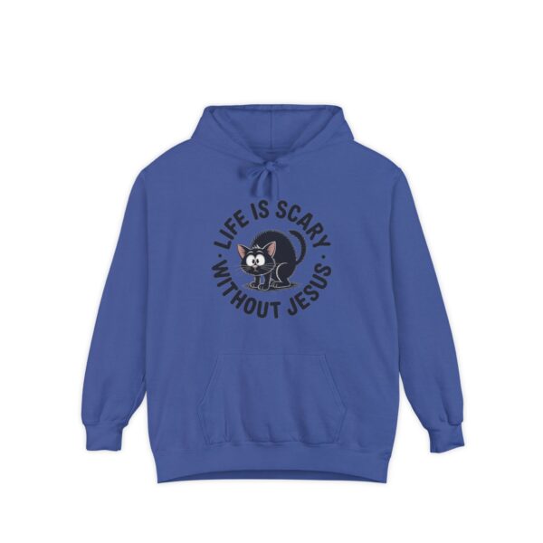 Model on a Halloween set wearing a blue Life is Scary Without Jesus Halloween Hoodie, design showing a cute frightened black cat.