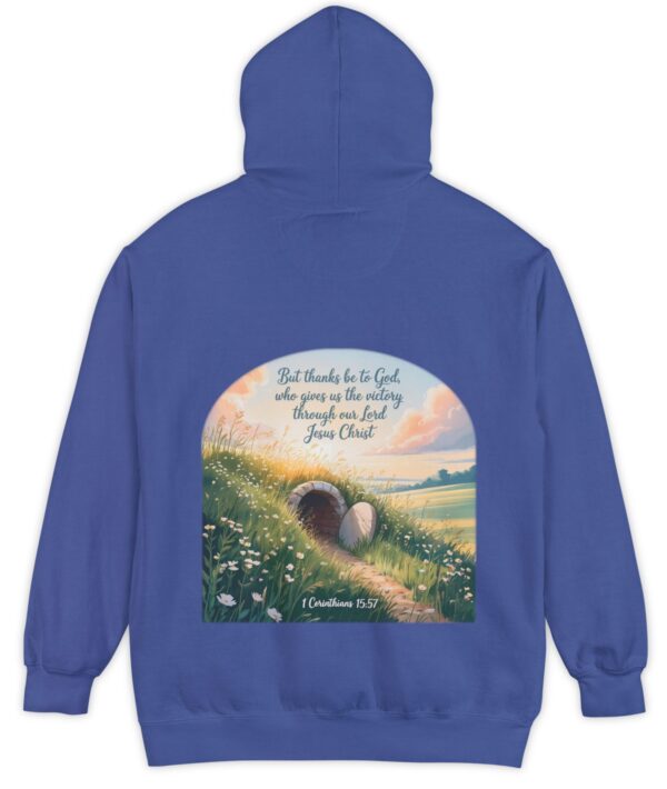 Royal blue Comfort Colors hoodie sweatshirt with a field and an open tomb with the rock rolled away. Printed on it is 1 Corinthians 15:57 But thanks be to God, who gives us the victory through our Lord Jesus Christ.
