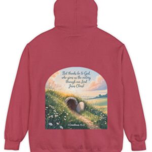 Red Comfort Colors hoodie sweatshirt with a field and an open tomb with the rock rolled away. Printed on it is 1 Corinthians 15:57 But thanks be to God, who gives us the victory through our Lord Jesus Christ.