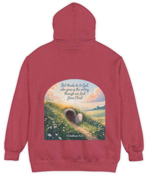 Red Comfort Colors hoodie sweatshirt with a field and an open tomb with the rock rolled away. Printed on it is 1 Corinthians 15:57 But thanks be to God, who gives us the victory through our Lord Jesus Christ.