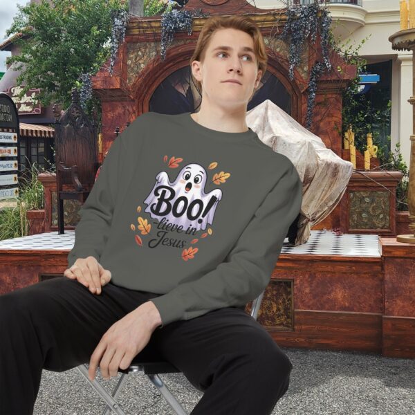 Model on a Halloween set wearing a Gray Boo! -lieve in Jesus Halloween Sweatshirt, design showing a cute ghost with fall leaves.